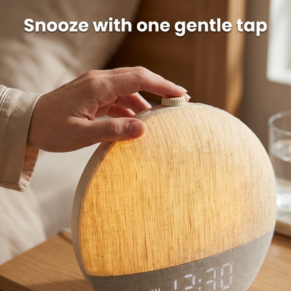 Snooze with one gentle tap — fingertip on the Dawnly top knob, glowing linen close-up