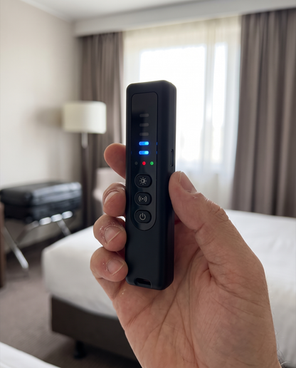Privly detector held in one hand in a hotel room, showing its pocket size